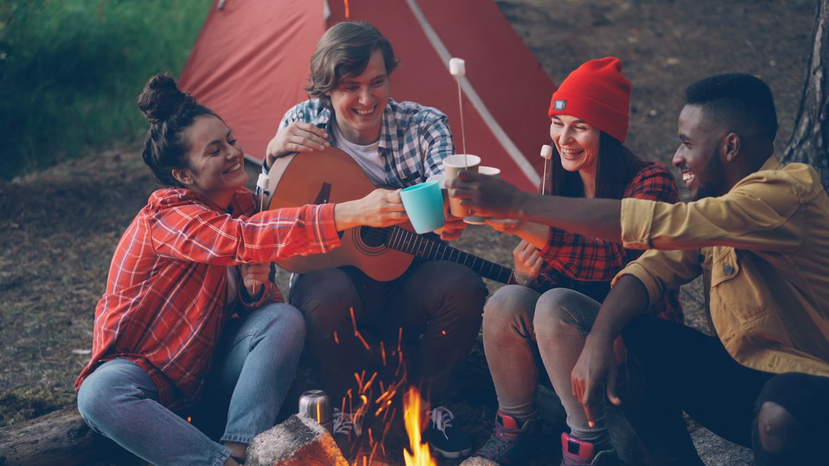 Happy campers gathered around a campfire